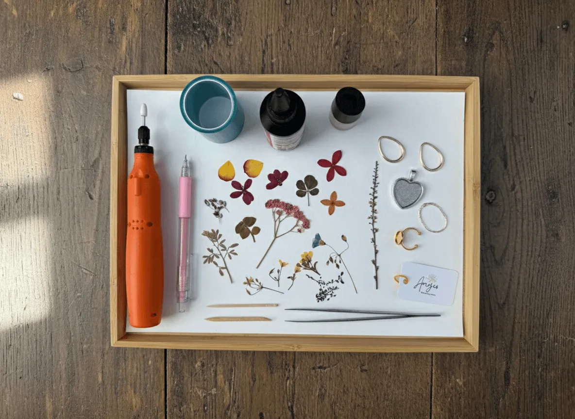 A beautifully arranged flat lay of tools: tweezers, resin, dried flowers, and molds