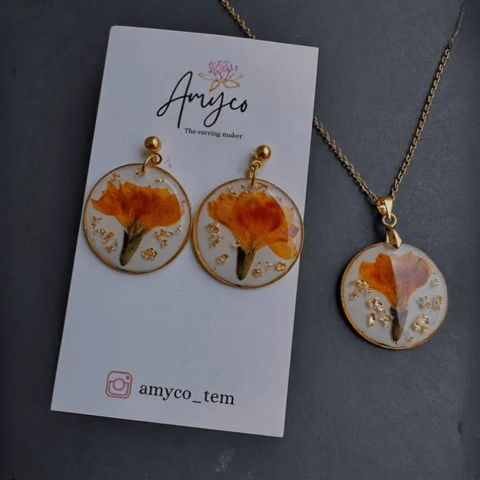 An elegant flat lay featuring a few jewelry pieces with gift boxes and a silk ribbon